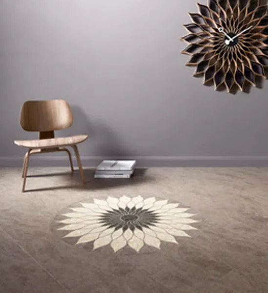Stone-effect vinyl floor inlaid with a bespoke cream and grey sunflower medallion, below a matching wall clock.